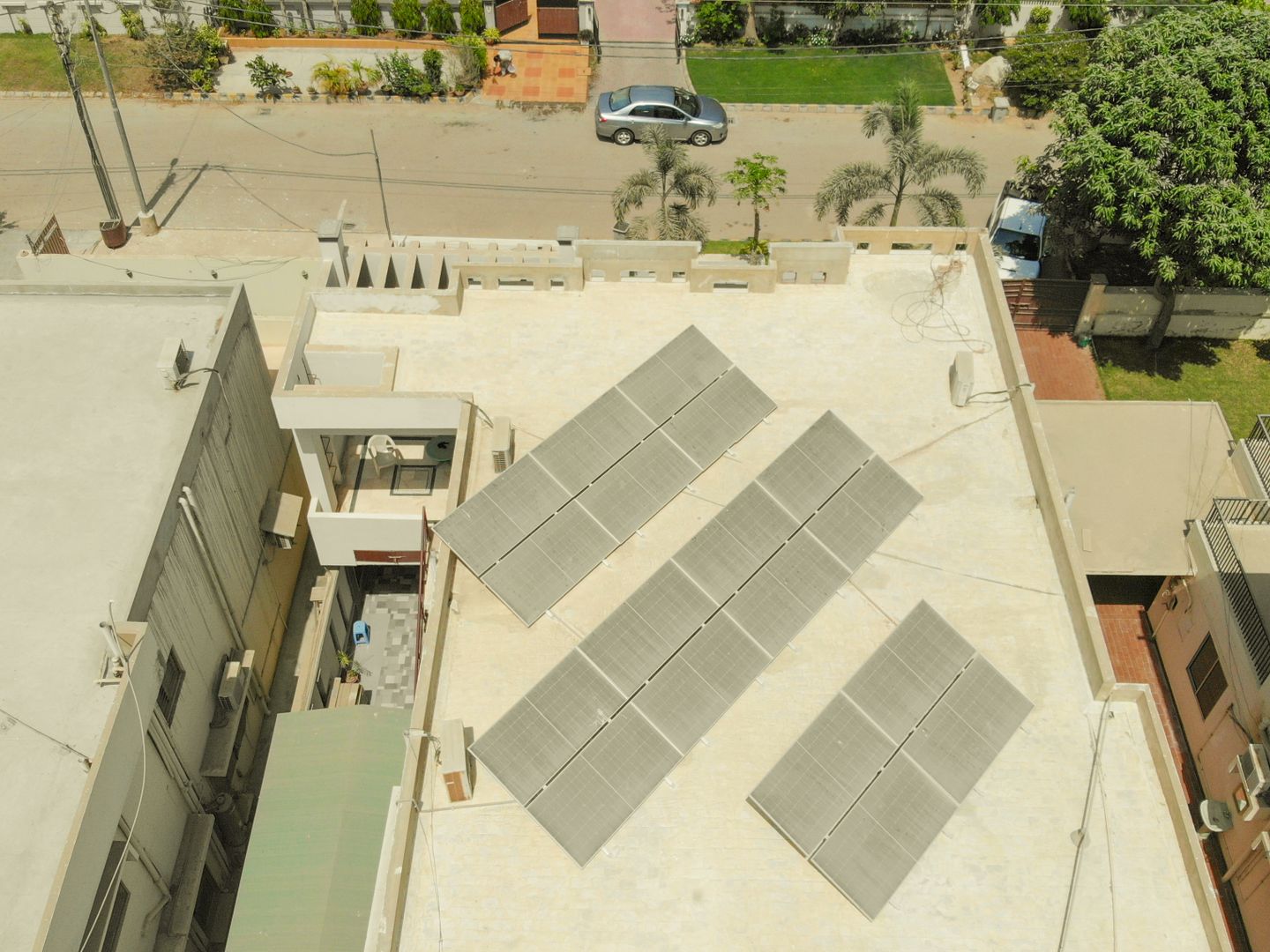 Aerial shot of solar panels on a rooftop in Karachi, highlighting sustainable energy solutions in urban settings.