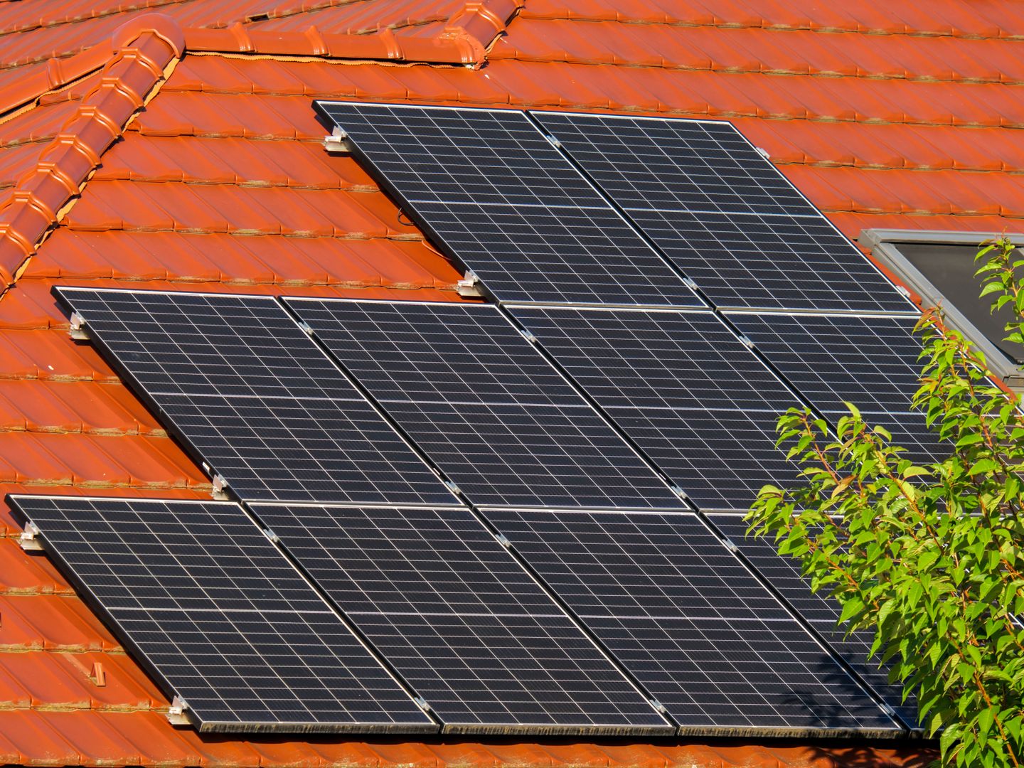 Close up of solar panels on a red tiled roof in Croatia, highlighting renewable energy.
